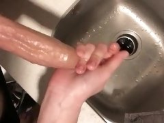 Jerking him off and edging him oiled up in the sink