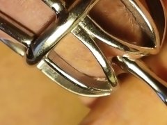 Urethral sounding for locked in chastity  cage cock. Close up.